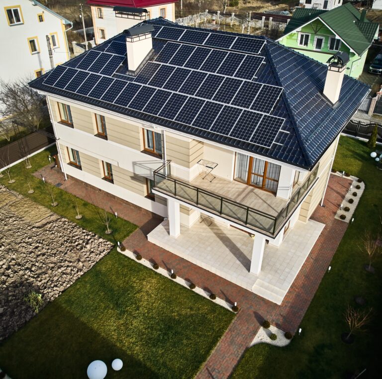Residential house with solar panel modules on rooftop.